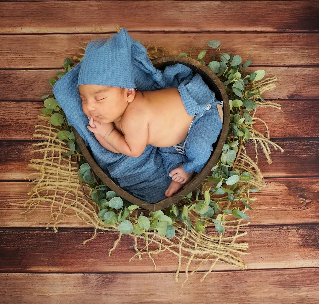 Newborn baby sleeping in a basket during a studio photography session with Adrisabel Photography in the Rio Grande Valley