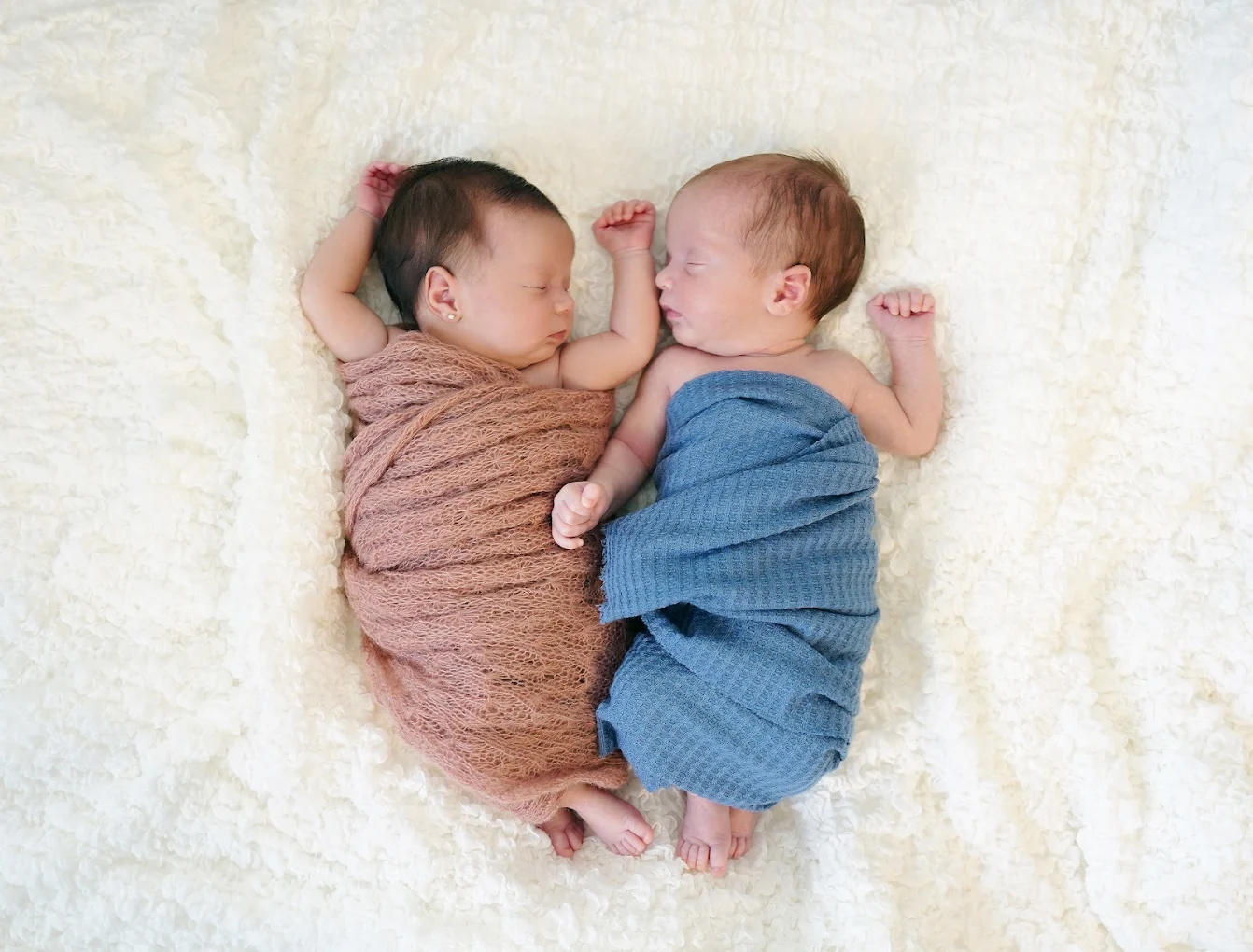 Twin newborn babies sleeping peacefully during a professional twin photography session in the Rio Grande Valley